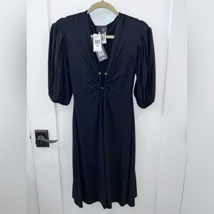 Just Cavalli Black Italian dress. I’m 5’4. Dress falls just below my knees.